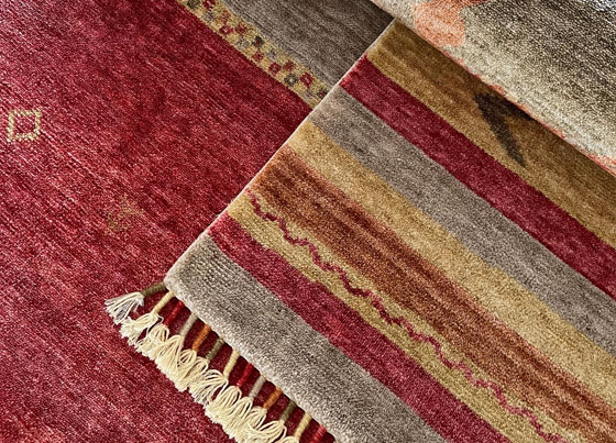 Zara: The labor intensive rug weaved on special looms with tencel and put through hand made rug processes subsequent to weaving - inspired and created from traditional rug making skills of women from Ushak region - increased durability with exclusive dying process
